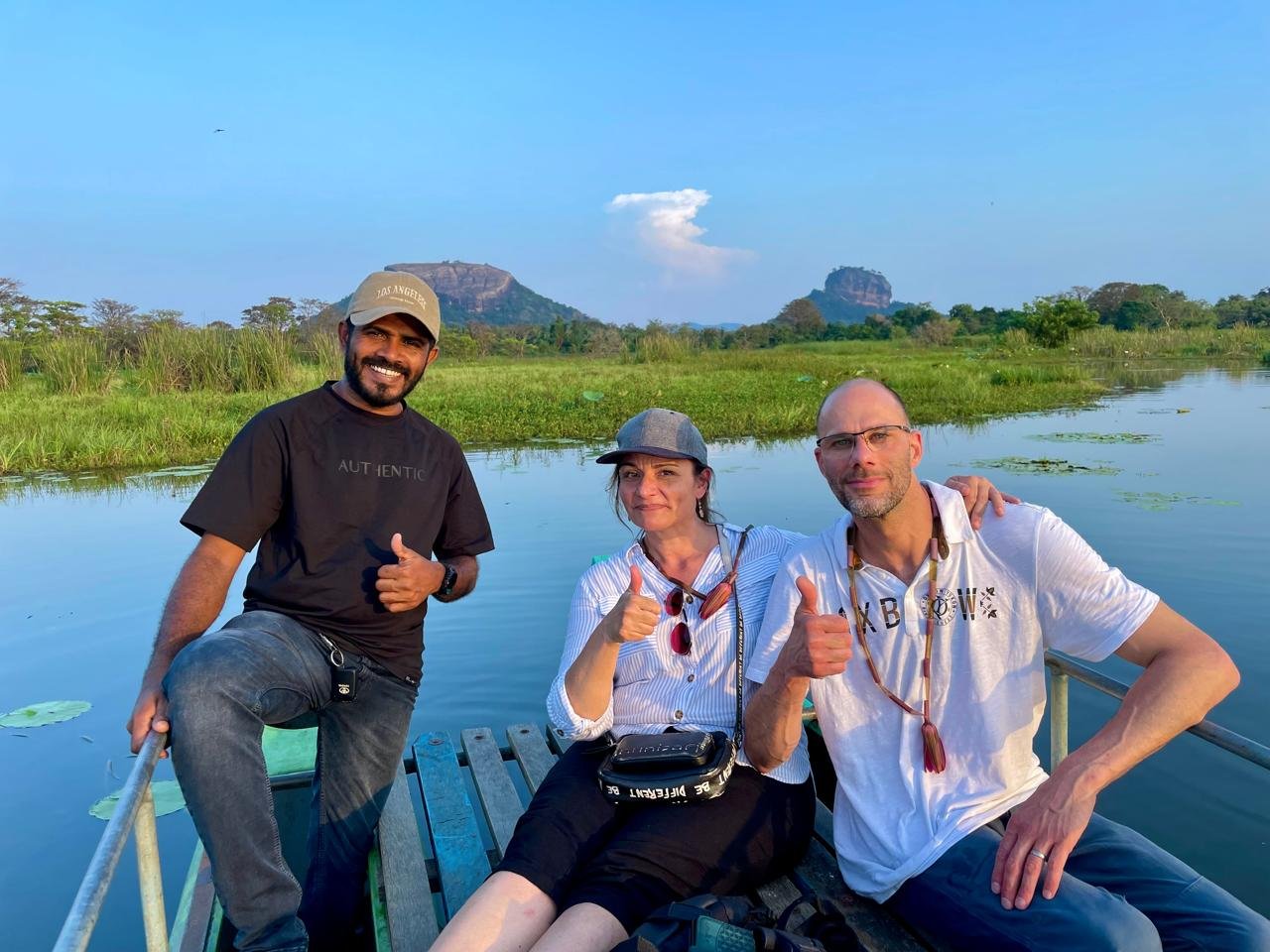 Sri Lankan guide with two travellers during a lake experience