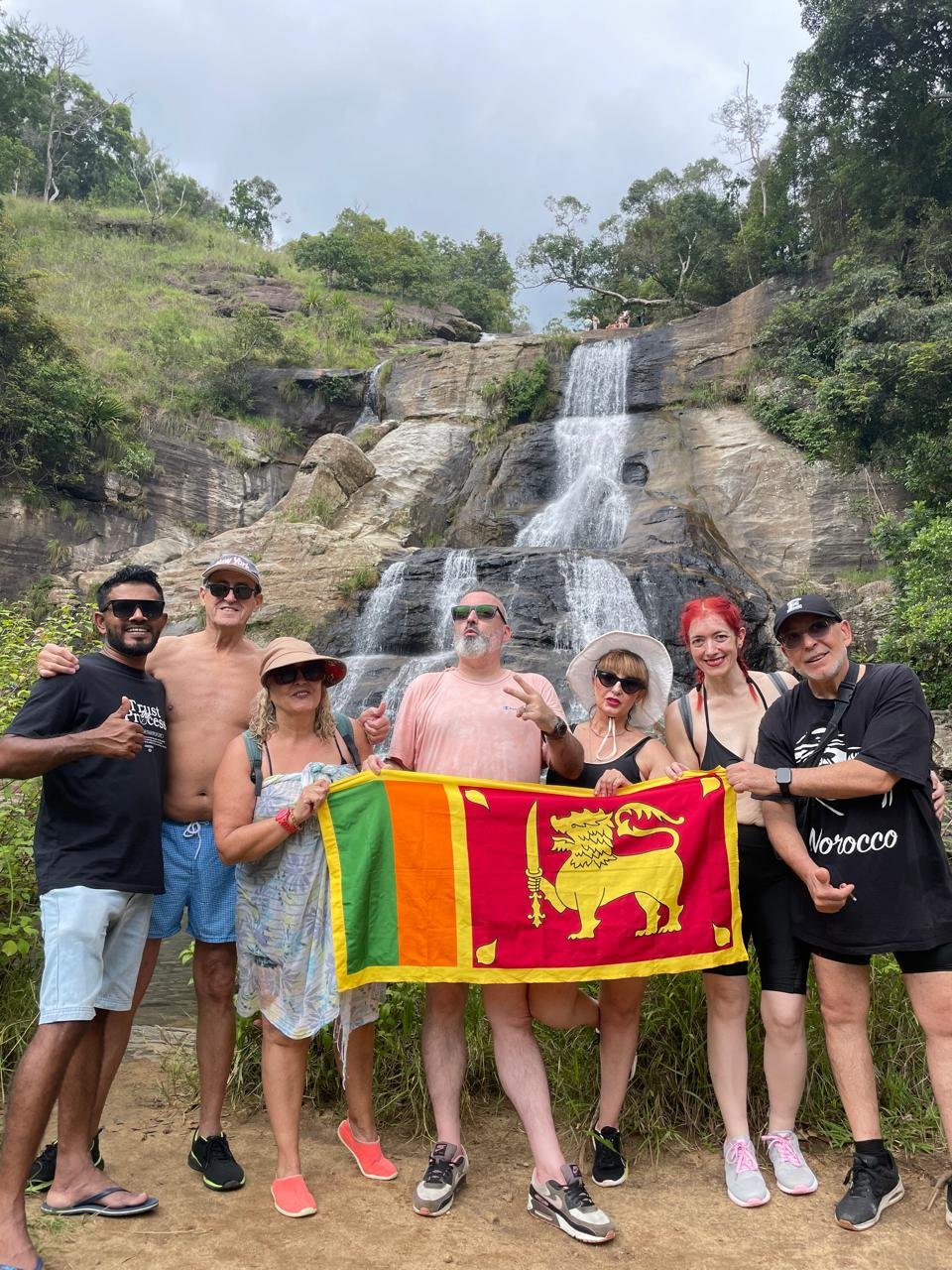 Travellers visiting a Sri Lankan waterfall